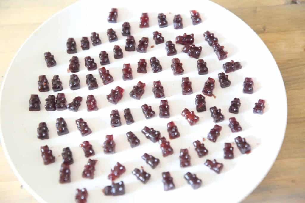 Homemade fruit gummies on a white plate.