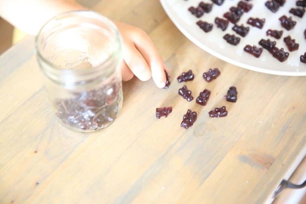 Homemade fruit gummies on a wooden table.