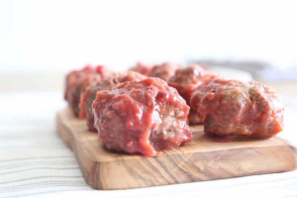 cranberry chili meatballs on cutting board