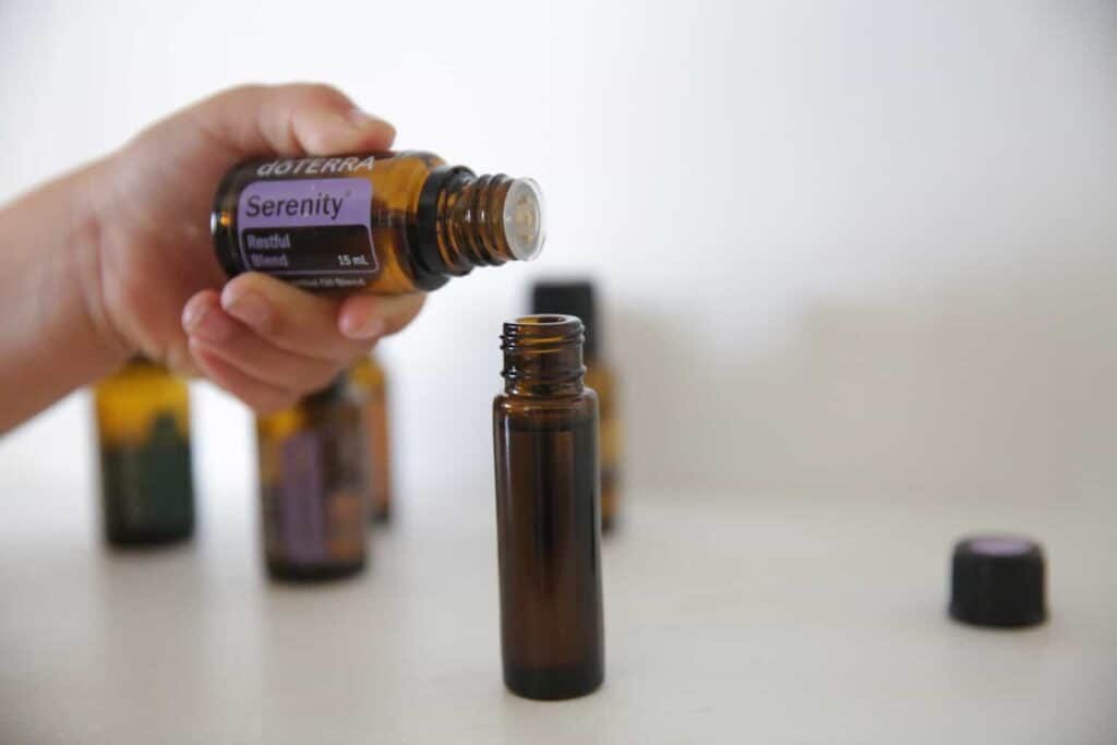 Adding Serenity essential oil to a bedtime roller bottle.