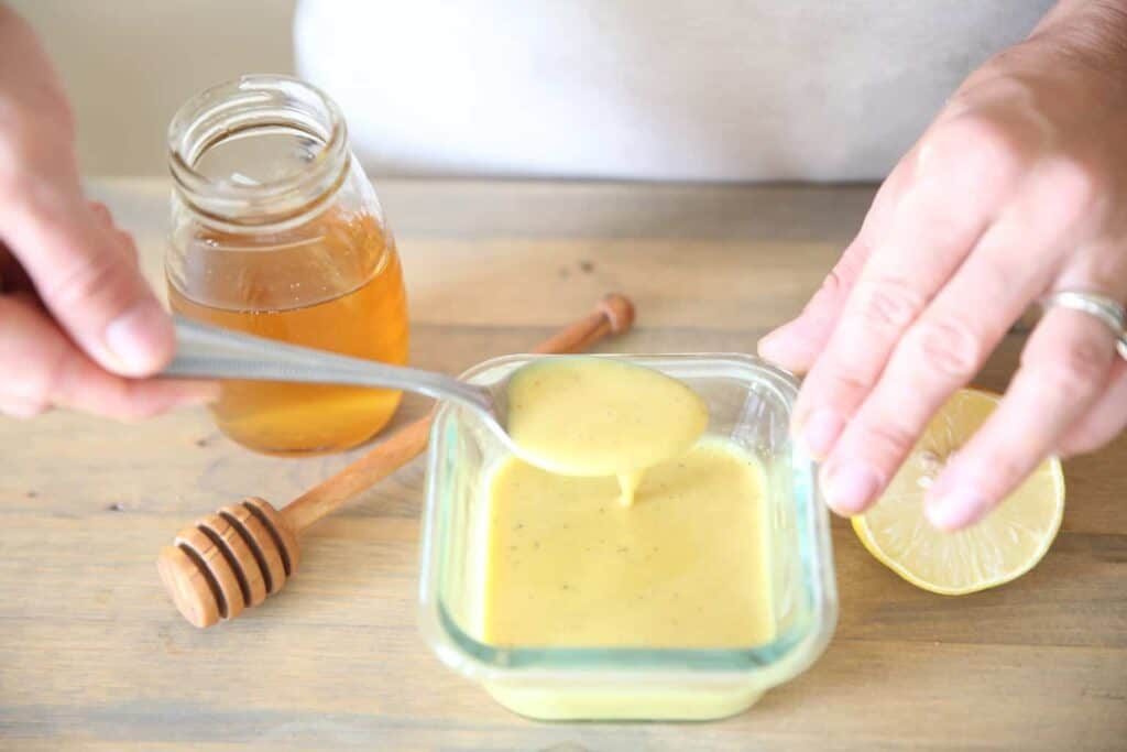 mixing ingredients for a lemon honey mustard dressing
