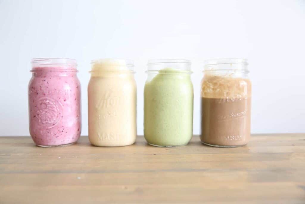 4 healthy smoothies in small glass jars