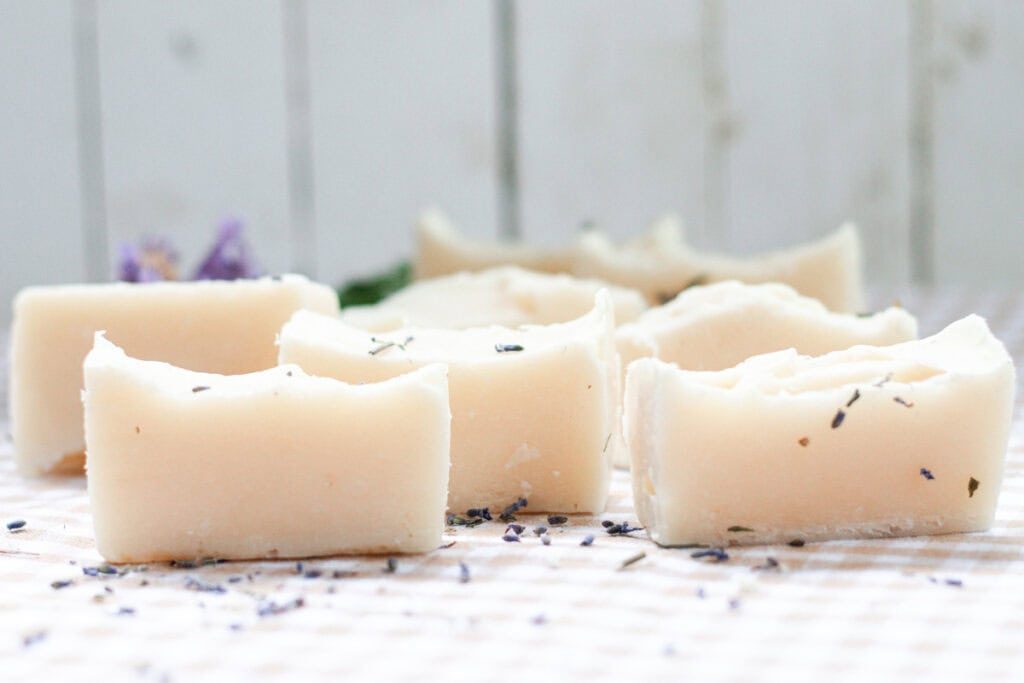 Cold process baby soap bars curing on a white table.