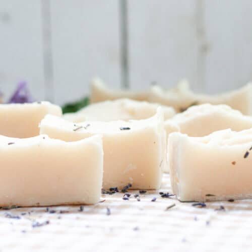 Cold process baby soap bars curing on a white table.