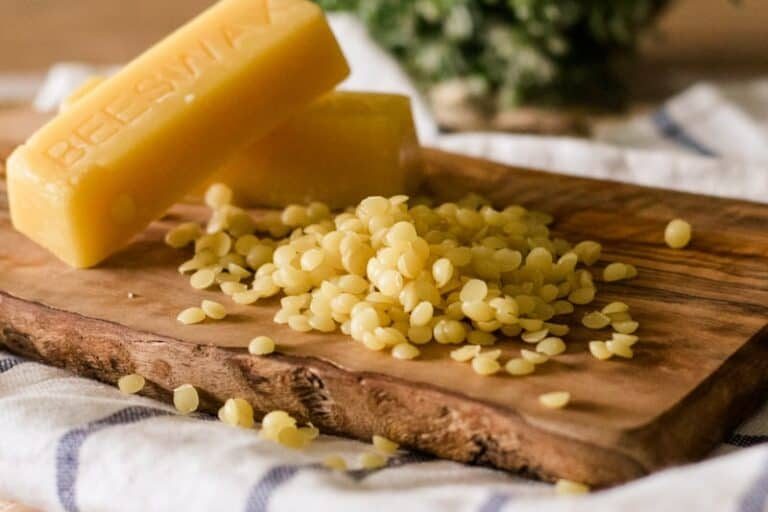Grated beeswax on a wooden chopping board.