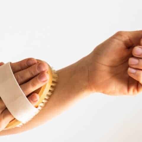 Dry brushing the forearm with a dry brush.