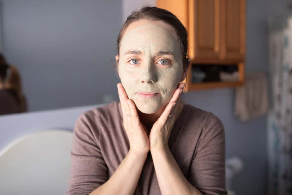 The author, the studio, with a bentonite clay face mask covering her face.