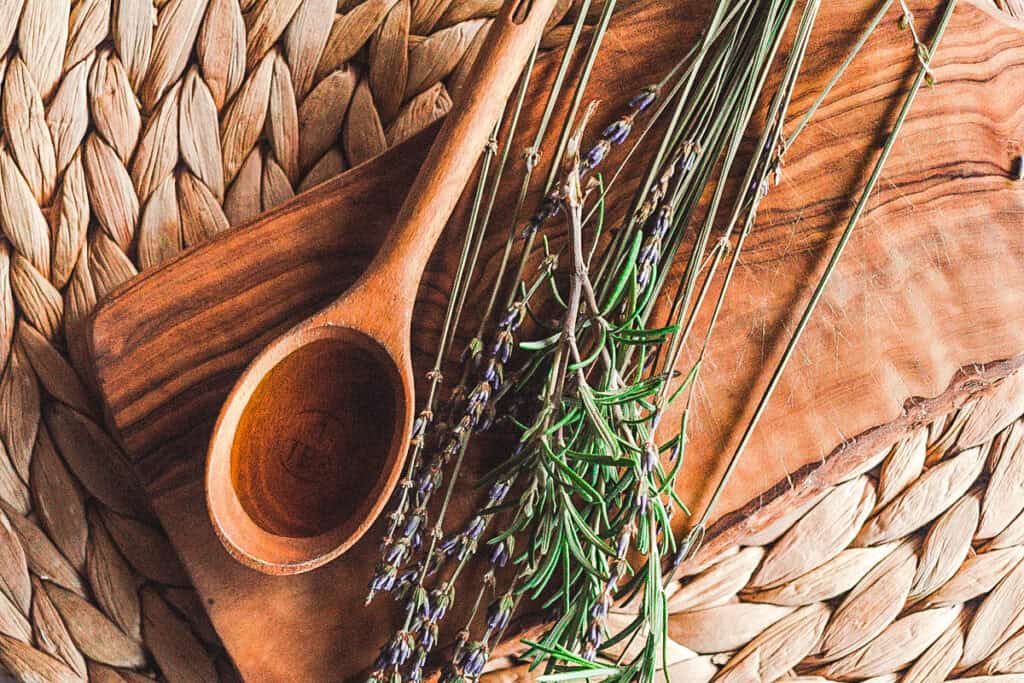 A small wooden spoon with black seed oil to be applied to the hair.