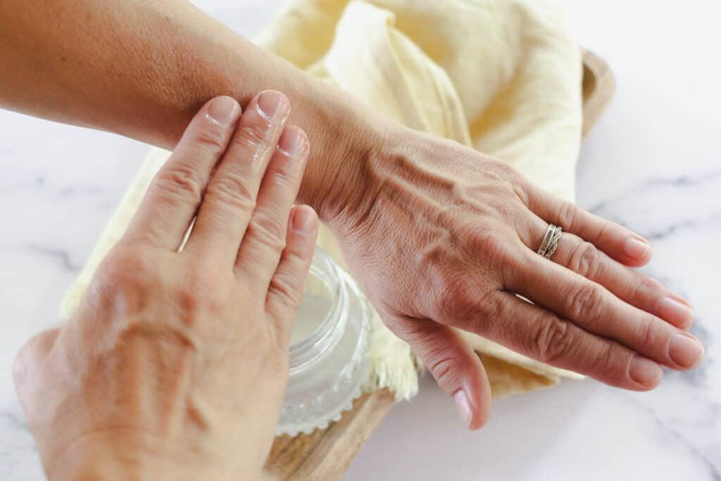Using coconut oil as a tanning oil and applying it to the skin with our fingertips.