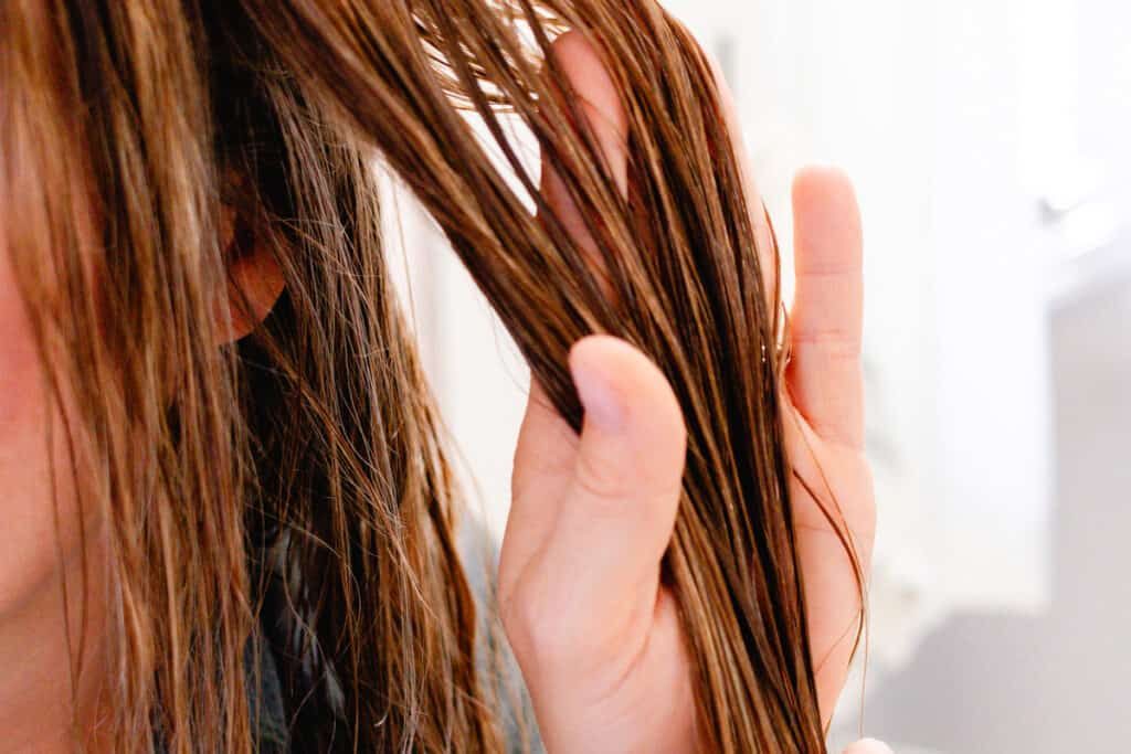 Holding out our clean hair to apply coconut water to hydrate it.