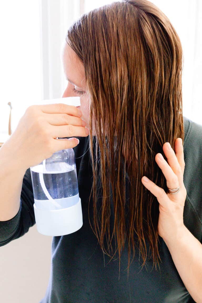 Spraying coconut water for the hair into our clean strands before conditioning.