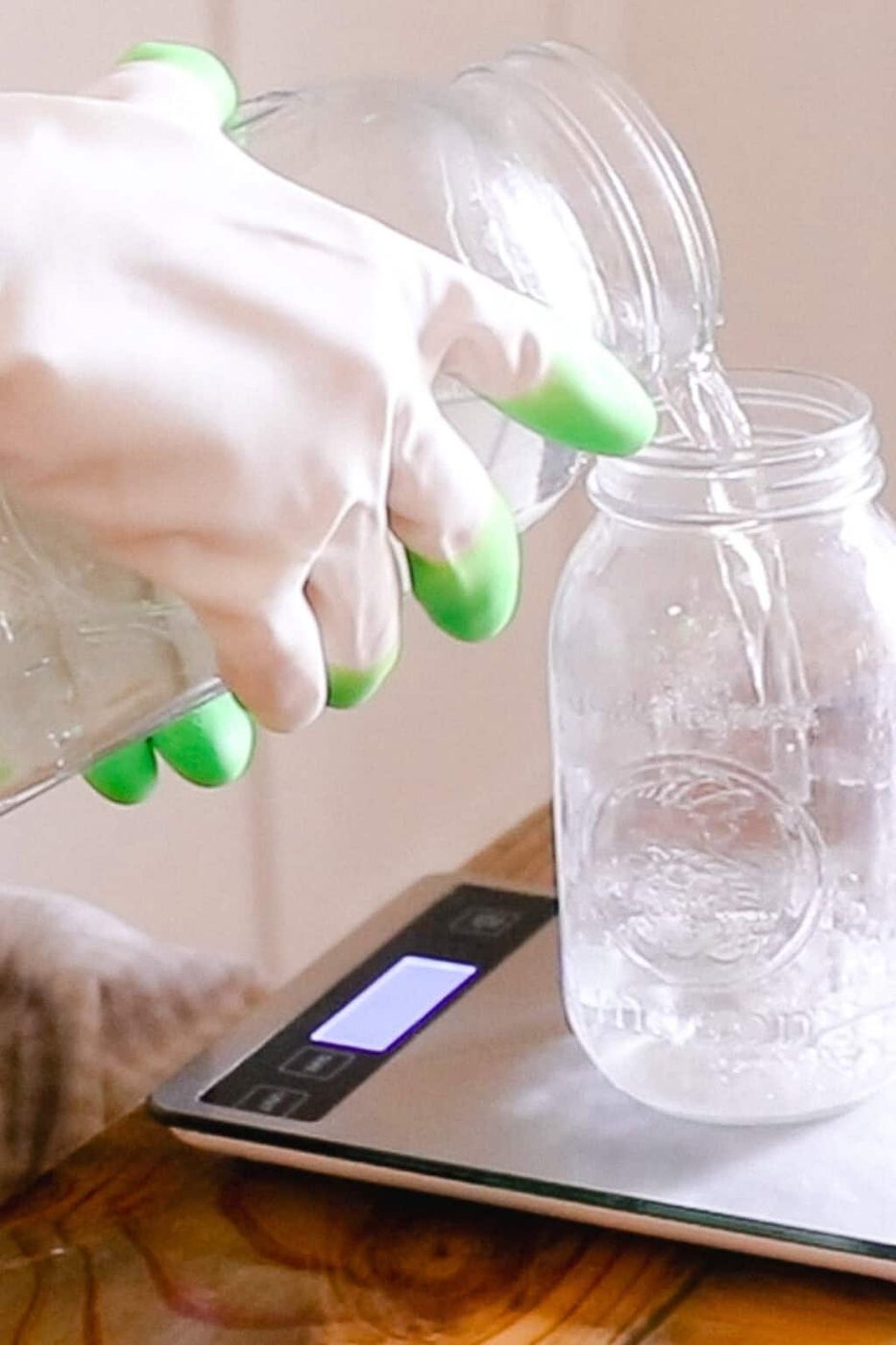 Pouring water into a large mason jar using a kitchen scale.