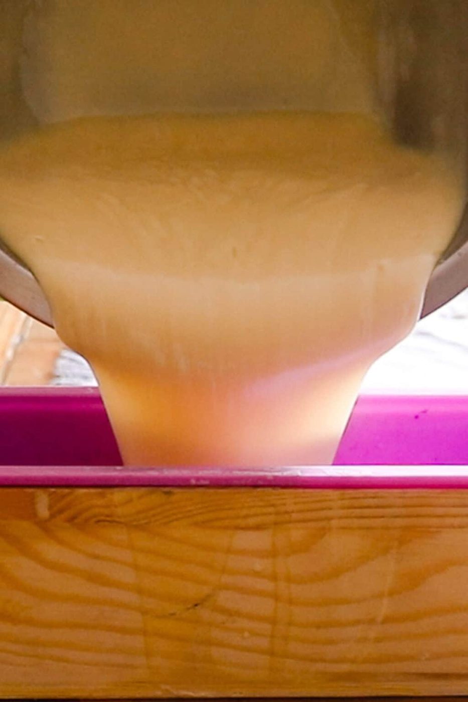 Pouring soap into a large loaf soap mold.
