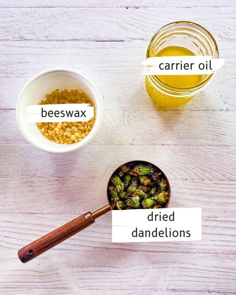 Dandelion salve ingredients labeled on a white table.
