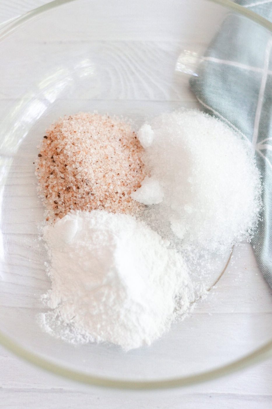 Ingredients for a foot bath poured into a glass bowl.