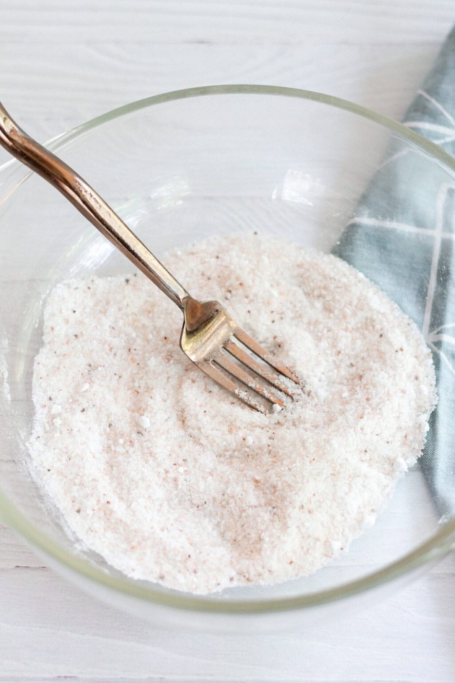 Dry ingredients for a detoxifying foot bath in a glass bowl, stirred well with a fork.