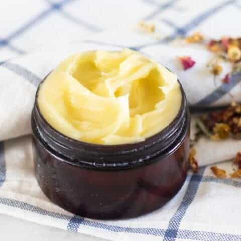 Anti-aging face cream in small amber container.