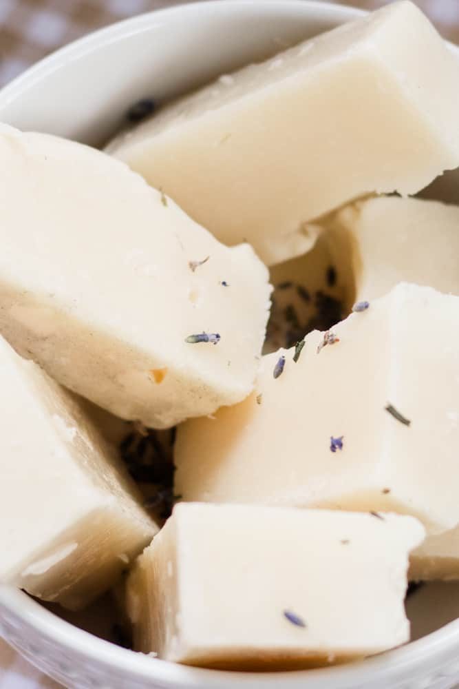 White bowl full of lavender soap bars.