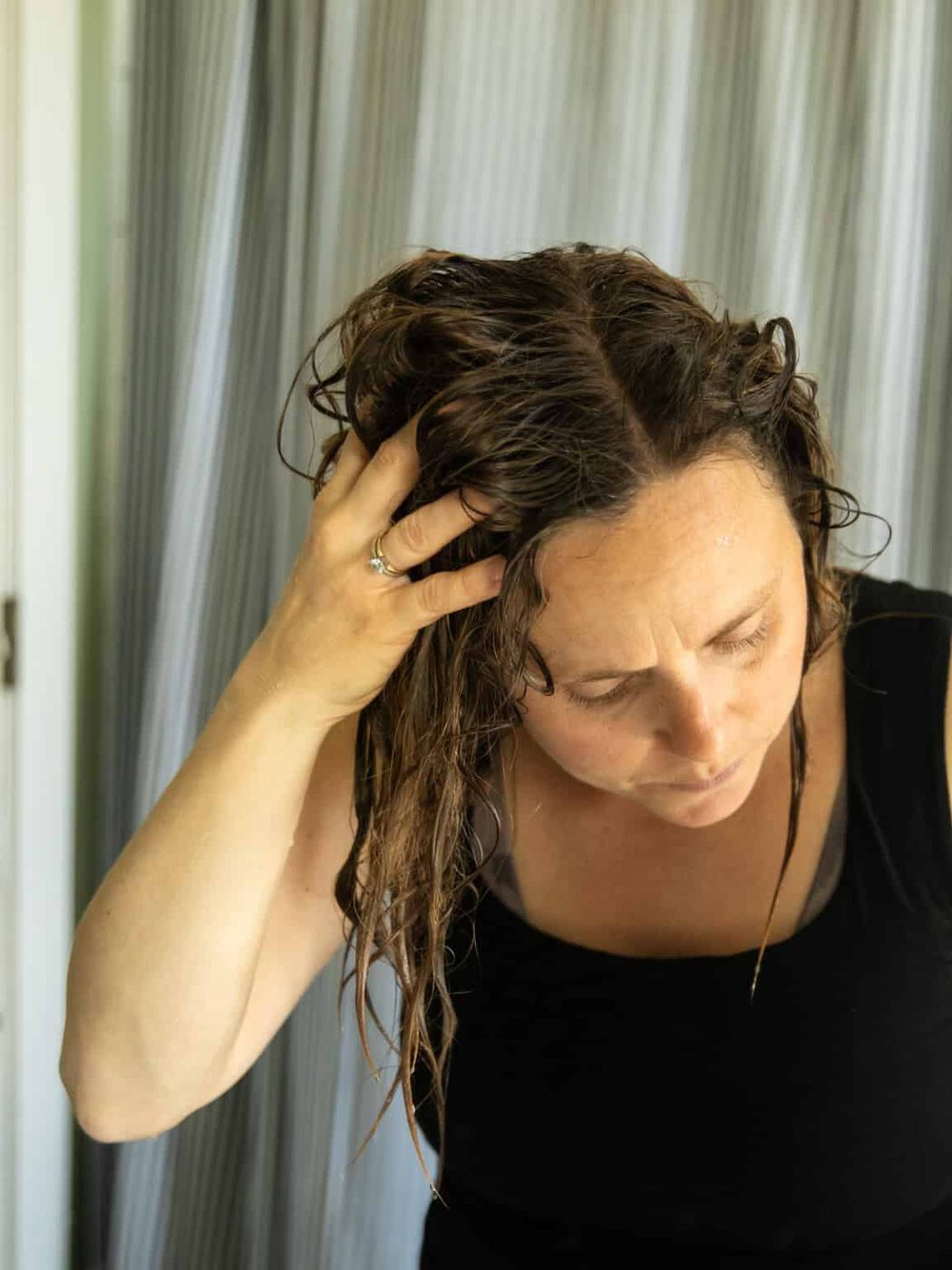 Massaging baking soda hair rinse into the hair and scalp.