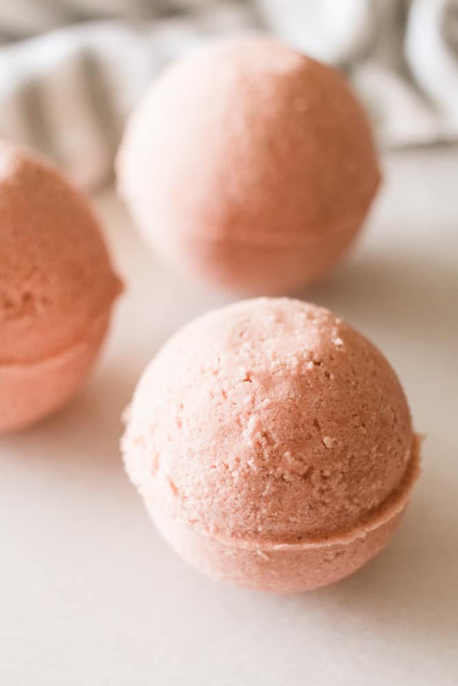 DIY pink bath bomb on white marble.