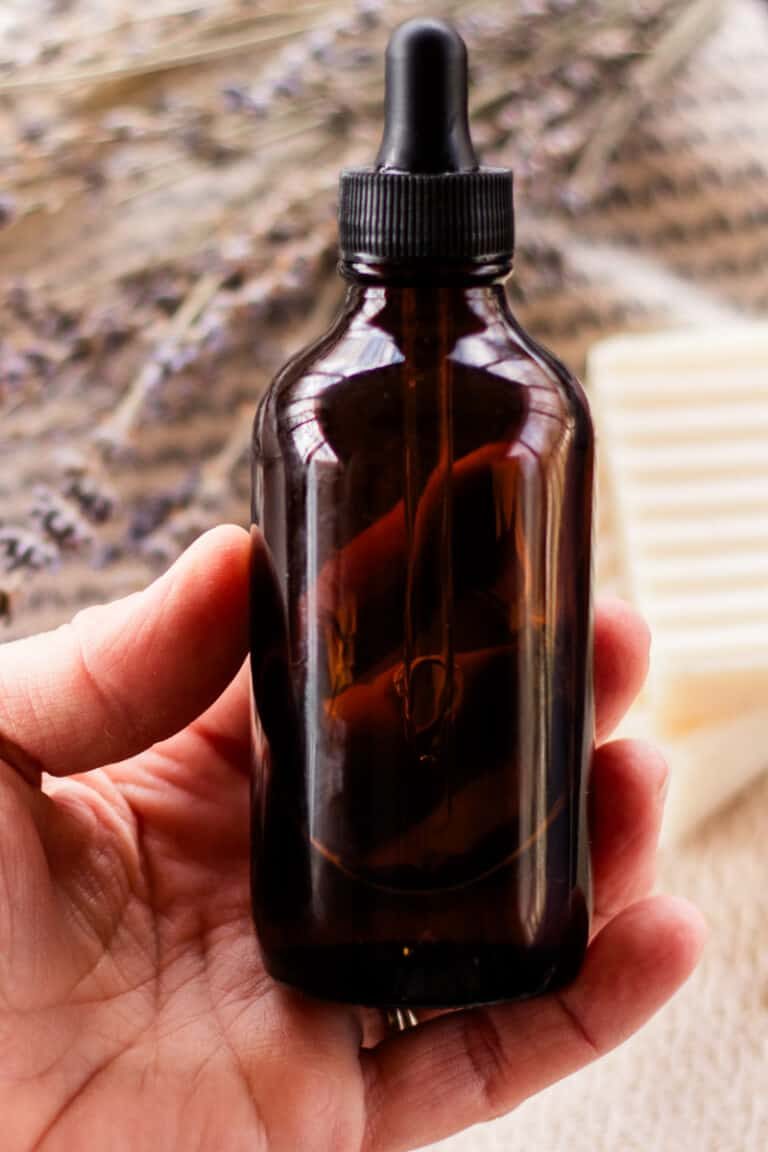 Holding a bottle of bath oil in our hands.