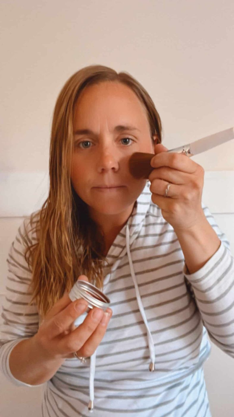 the studio adding diy blush cream to her cheekbones.