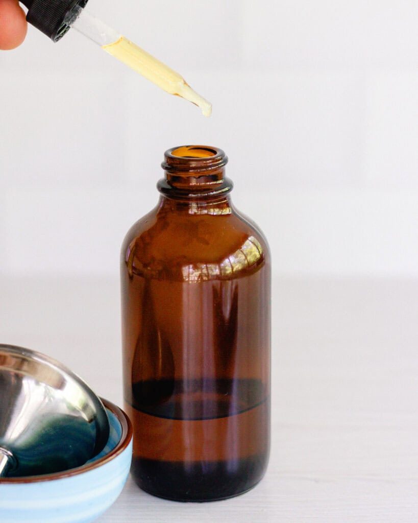 Dropped vitamin e oil into an amber glass bottle.