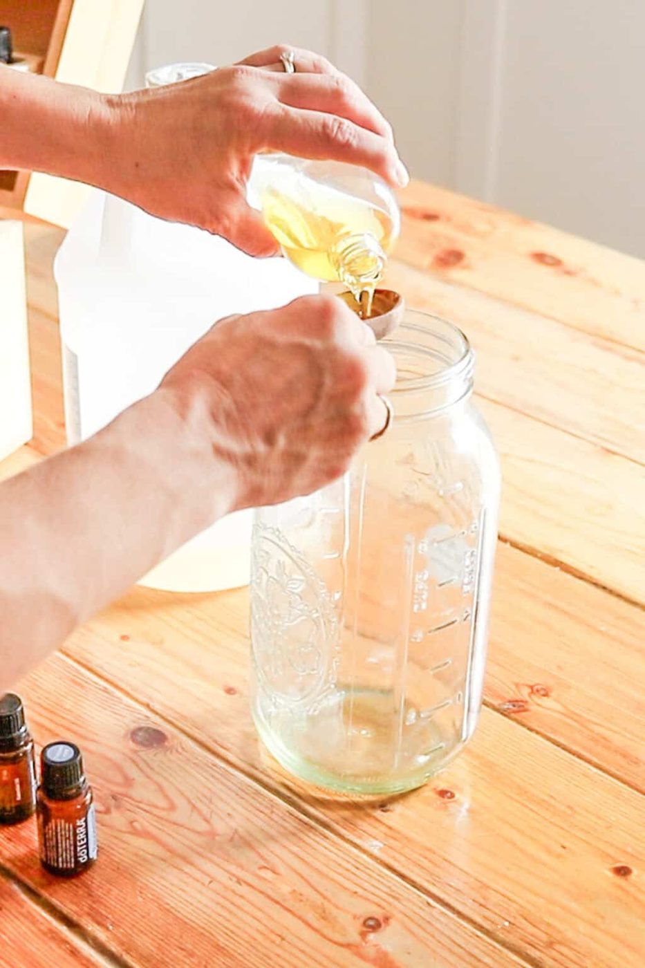 Adding neem oil to the spray bottle.