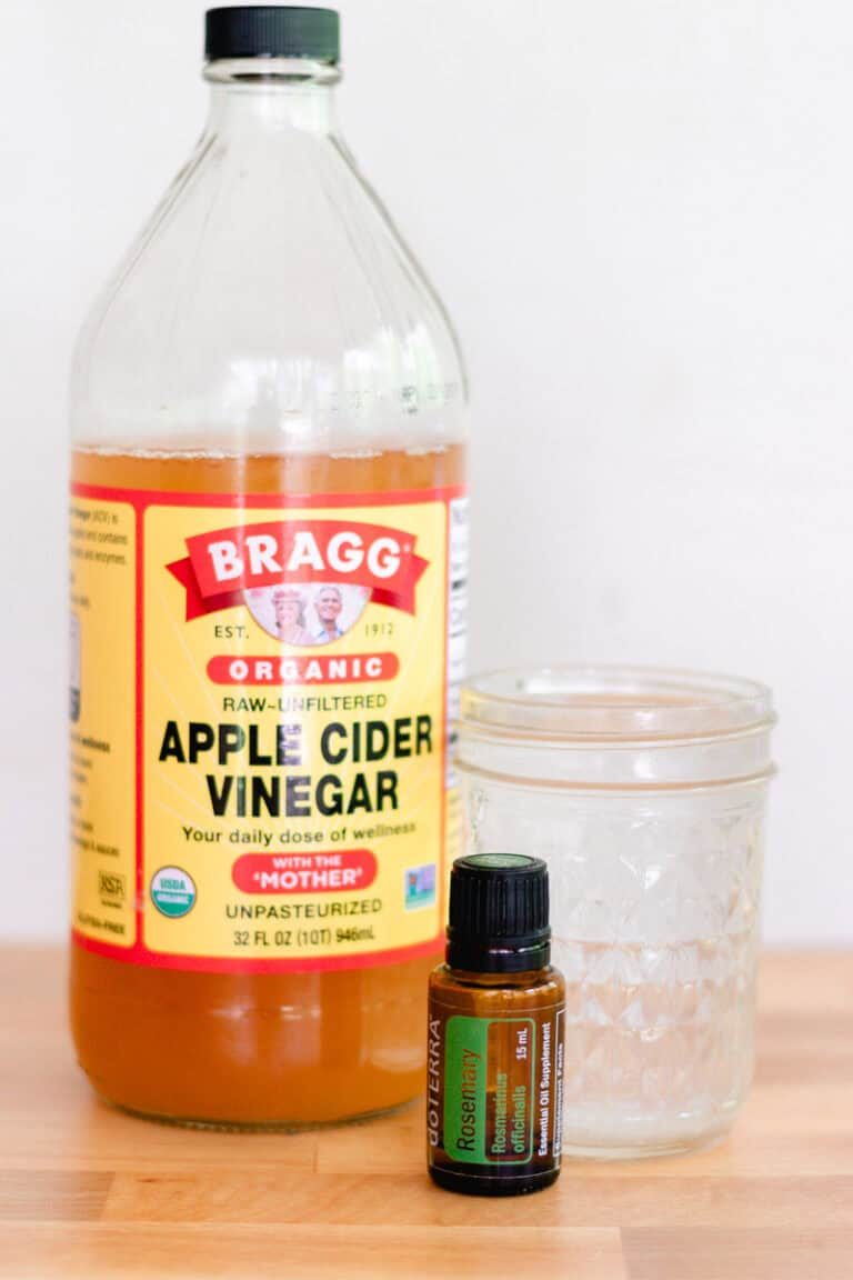 Ingredients for apple cider vinegar clarifying shampoo: apple cider vinegar, rosemary essential oil, and water.