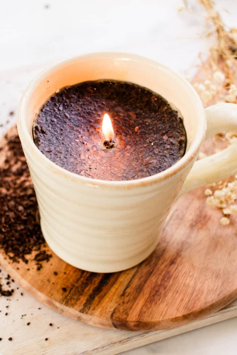 Lighting a DIY coffee candle for the first time after making it in a coffee mug.