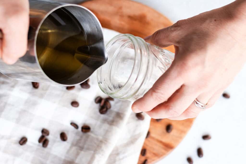 Pouring a little bit of the melted wax into a small jar.