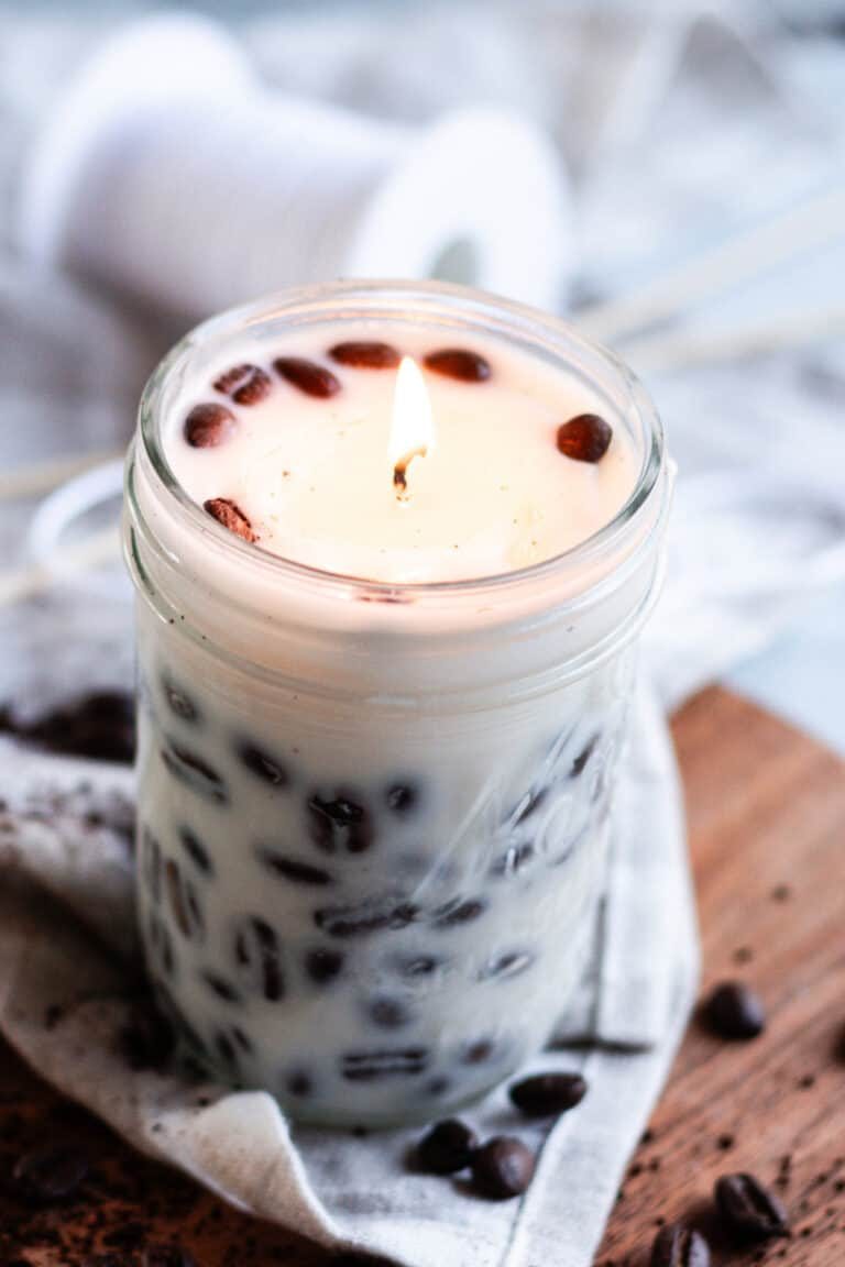A beautiful coffee scented candle with coffee beans pressed against the sides.