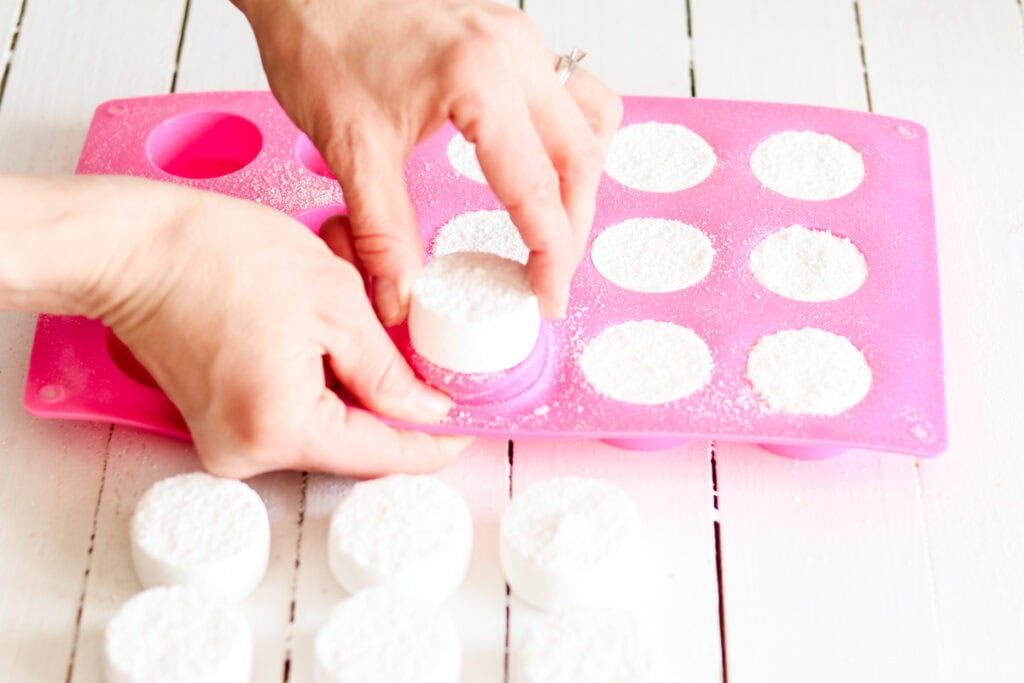 Popping the dried tabs out of the molds with our fingers.