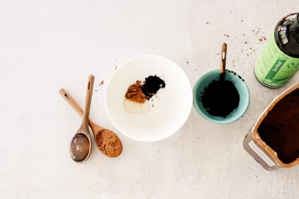 Adding the ingredients for the eyebrow tint to a small bowl.