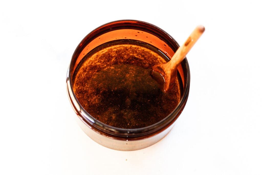 Stirring the foot mask ingredients in a small container.