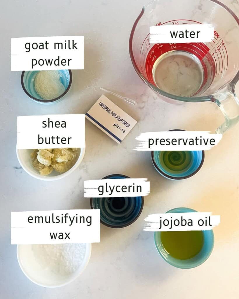 Goats milk lotion ingredients labeled on a white countertop.
