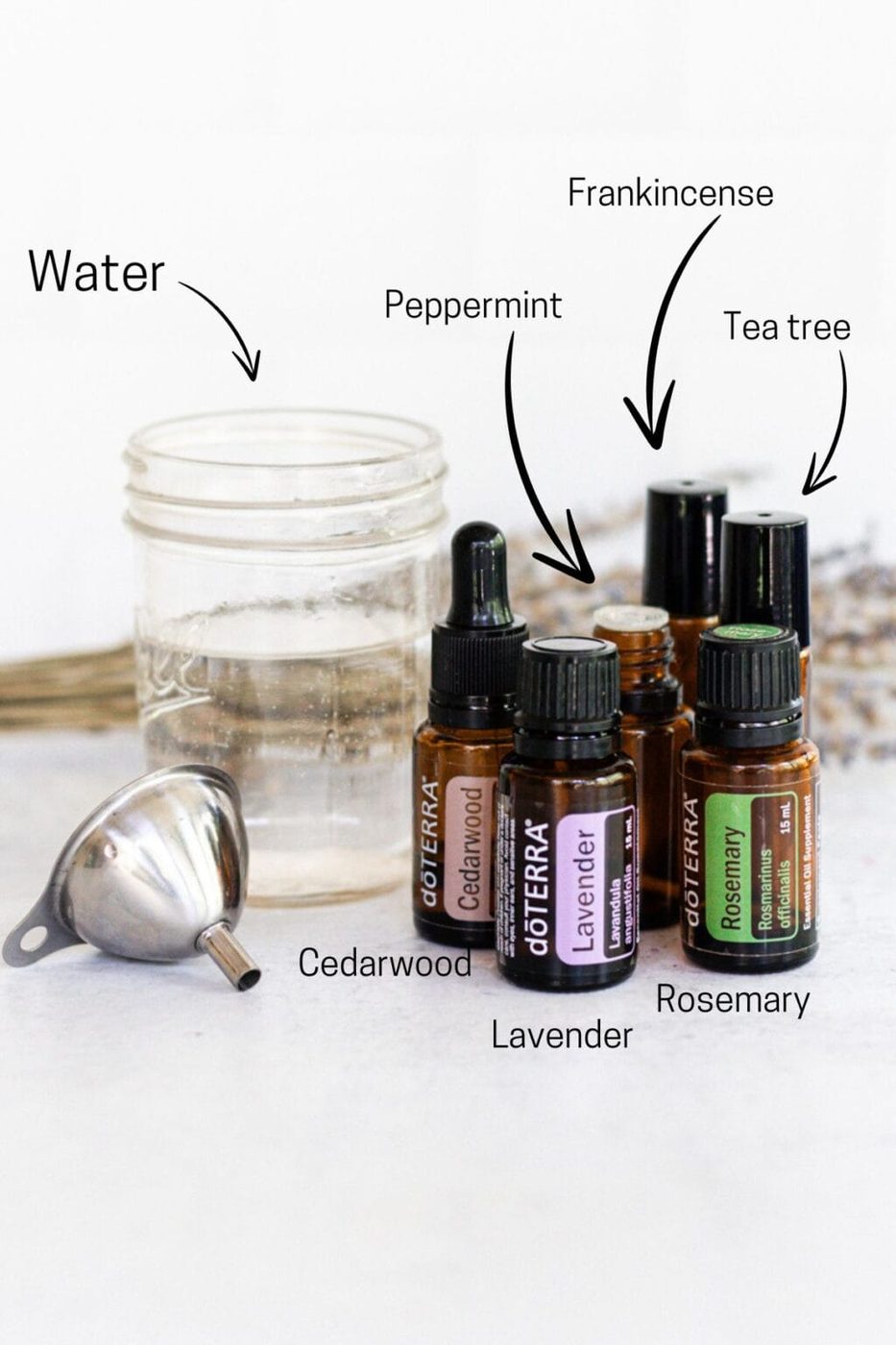 Ingredients to make hair growth spray: cedarwood, lavender, peppermint, frankincense, tea tree, and rosemary essential oils and water.