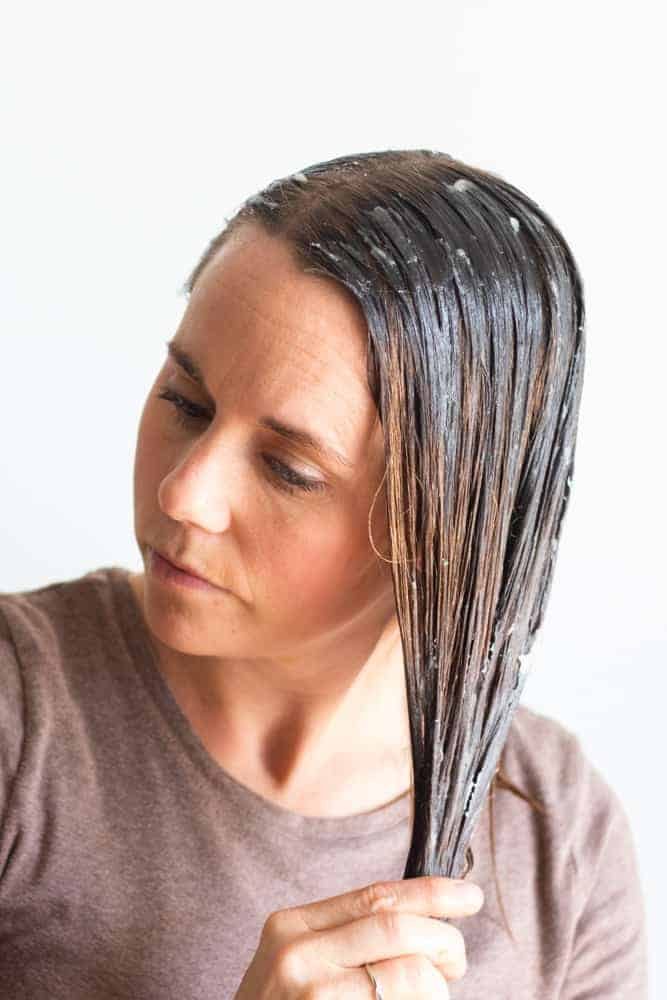 Women massaging hair mask into hair.