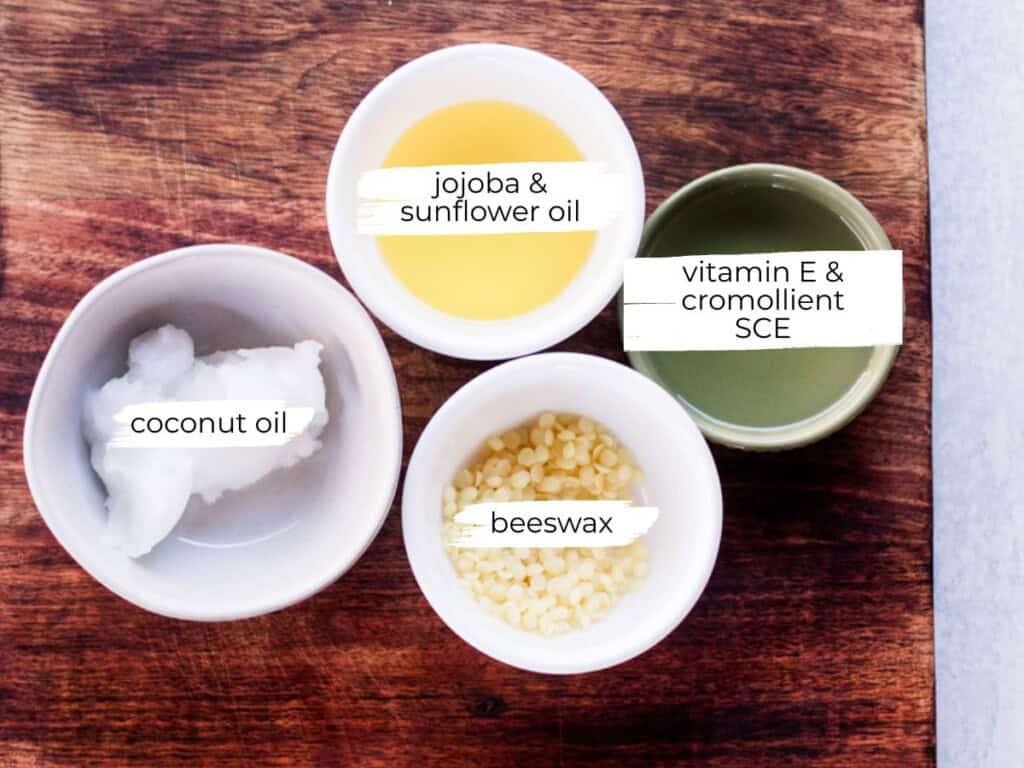 Hair pomade ingredients labeled on a wooden table.