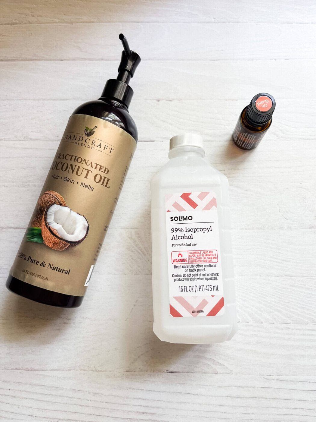 Hand sanitizer spray ingredients assembled on a white table.