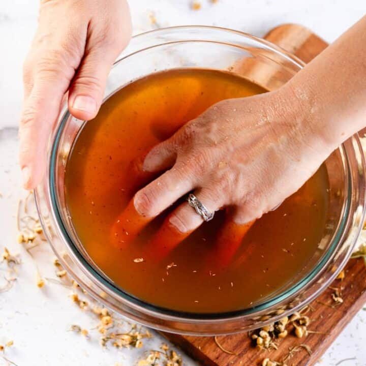 Soaking our hand in a chamomile hand soak.