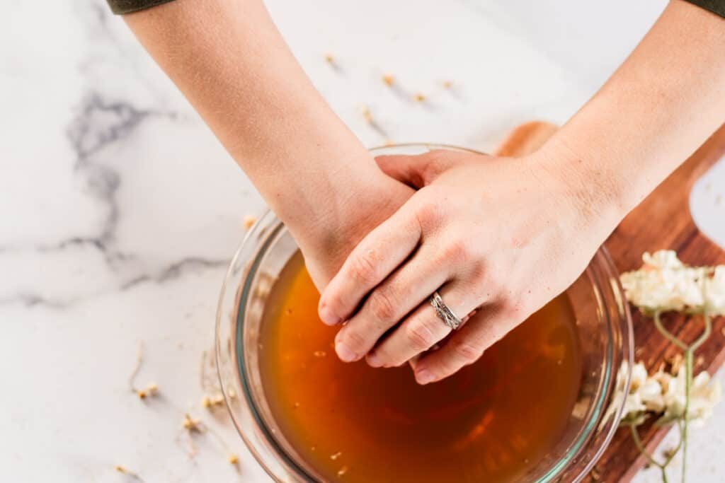 Putting hands into the soak.