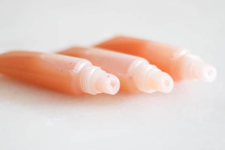 three tubes of pink lip gloss