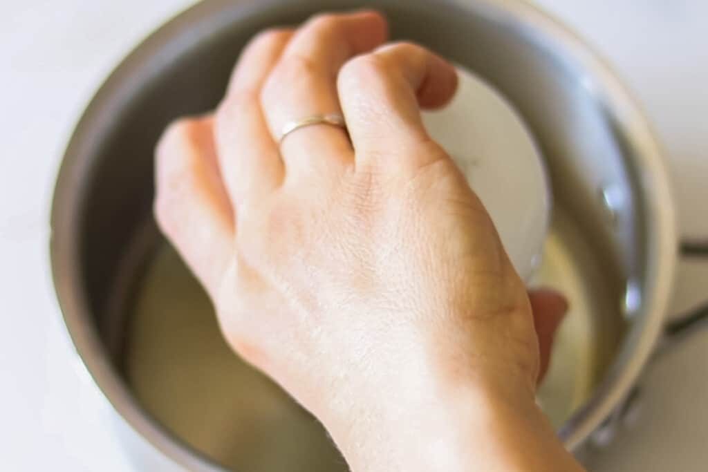 Pouring oil into a saucepan.