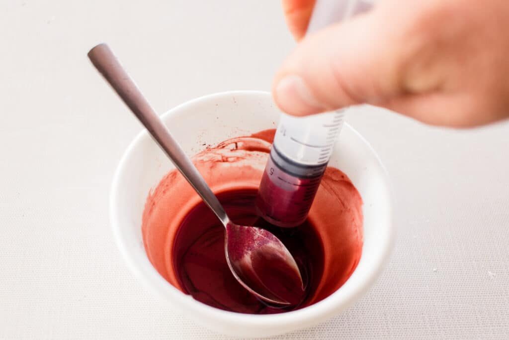 Mixing color into the DIY lip liner recipe.