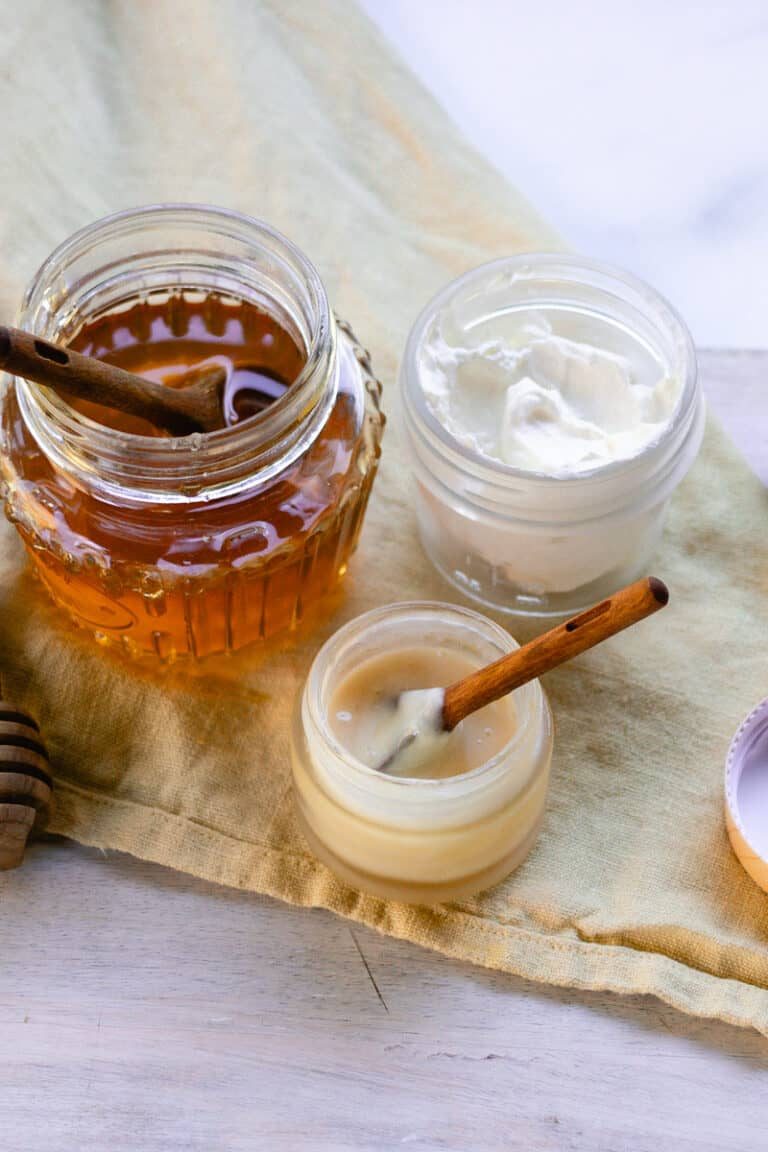 Our DIY lip mask recipe finished in a glass bowl with a wooden spoon.