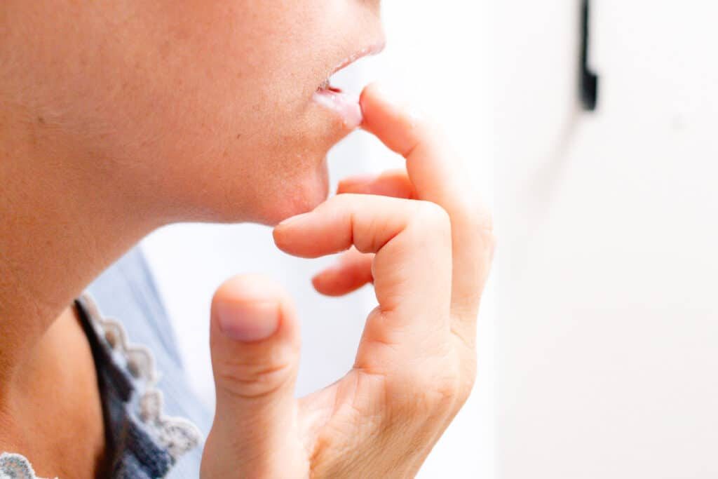 Applying the yogurt lip mask to our lips using our fingertips.