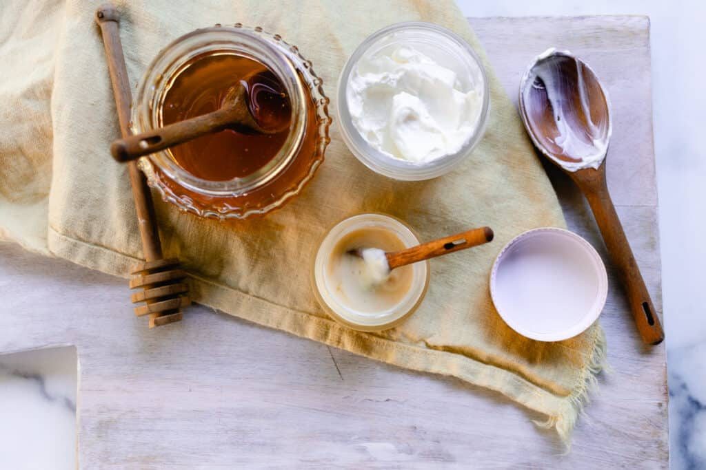 A homemade lip mask in a small jar with a spoon for stirring.