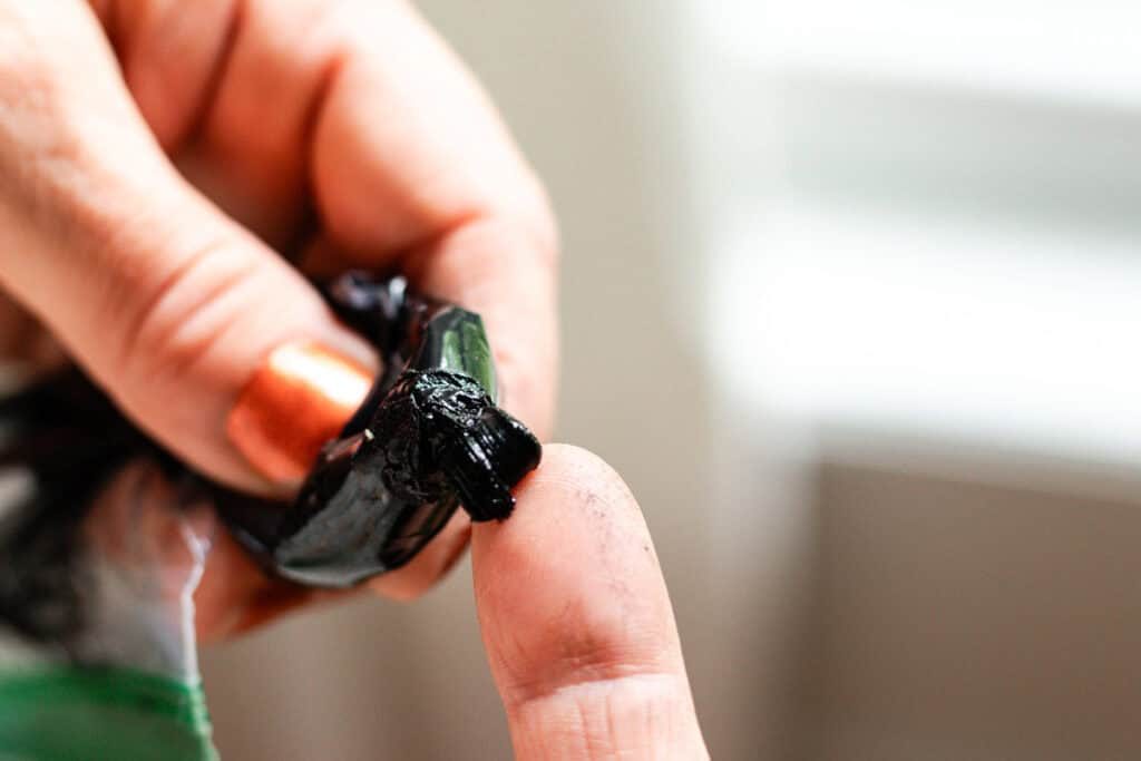 Checking the texture of the mascara coming out of the bag.