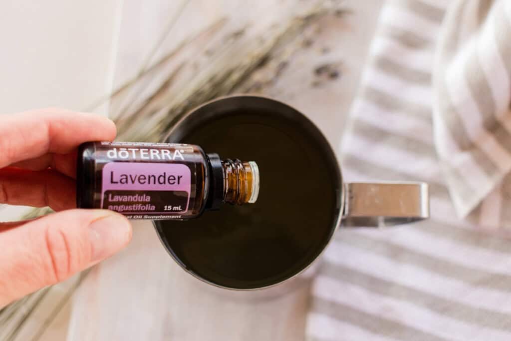 Dropping essential oils into a metal pitcher.